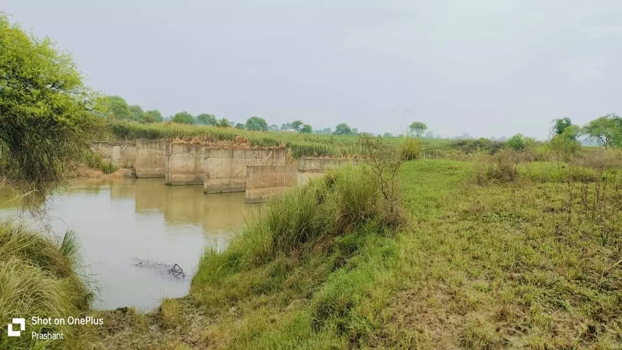 Villagers find standing bridge in irritated river, work to be completed in May 2018 still incomplete, claims of road construction still in the air