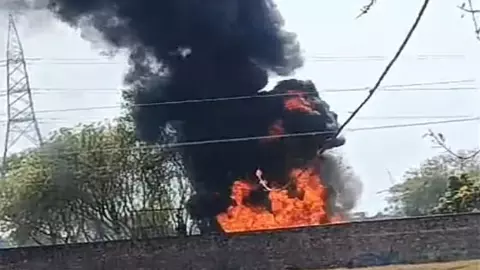 Tanker parked at oil depot catches fire
