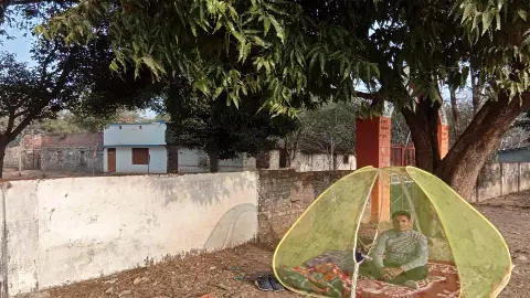 Amidst cough and heavy frost, a teacher sits on a sit-in tackling a school problem