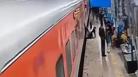 Two passengers slip into moving train, saved by GRP Two passengers slip into moving train, saved by GRP