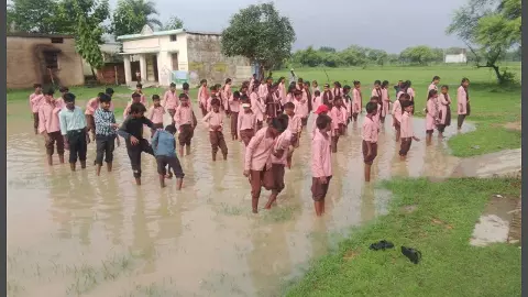 Tricolor hoisted standing in dirty water filling school premises Tricolor hoisted standing in dirty water filling school premises