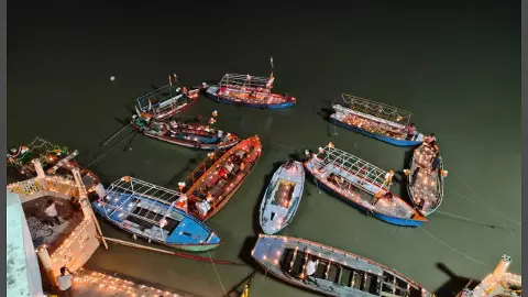 Thousands of lamps glistening on the waves and ships of Ganga