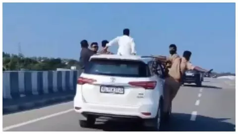 MP sitting on roof of car MP sitting on roof of car